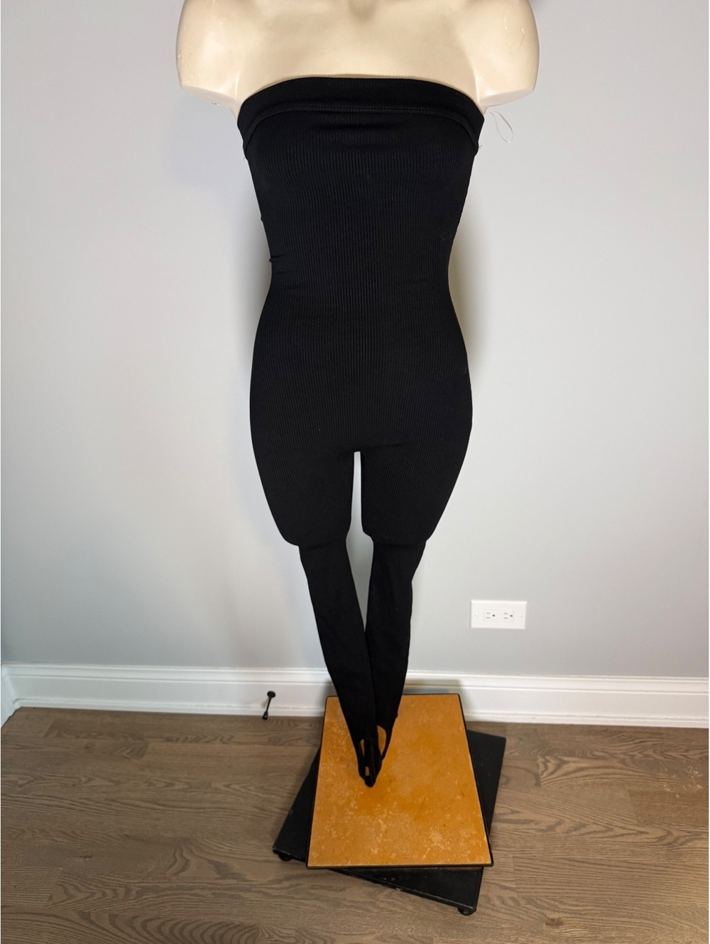 Naked Wardrobe Black Strapless Ribbed Jumpsuit with Stirrup